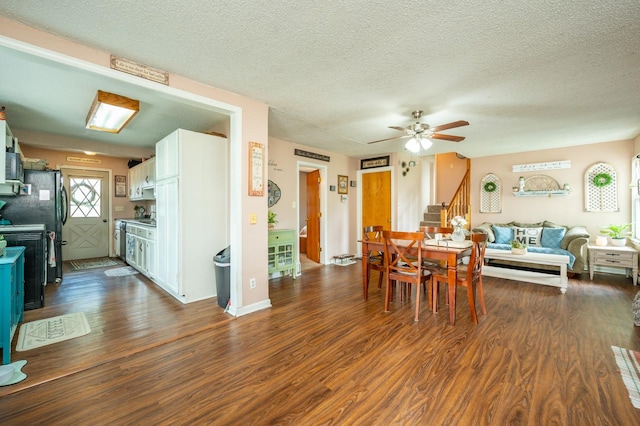 404 E 21st St S, Newton, IA 50208 - dining room featuring stairs, dark wood-style floors, a ceiling fan, and a textured ceiling