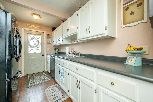 404 E 21st St S, Newton, IA 50208 - kitchen featuring black appliances, dark countertops, white cabinets, a sink, and dark wood-type flooring
