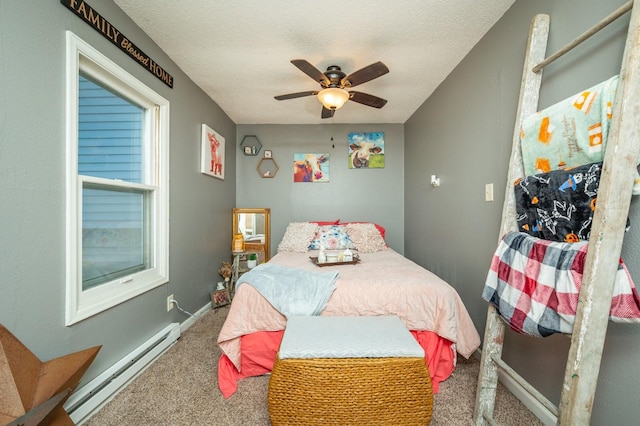 404 E 21st St S, Newton, IA 50208 - bedroom featuring baseboard heating, carpet flooring, a ceiling fan, baseboards, and a textured ceiling
