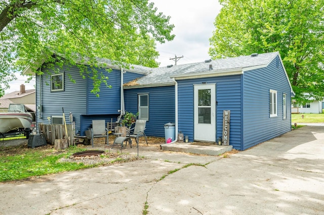 404 E 21st St S, Newton, IA 50208 - rear view of property with roof with shingles and a patio area