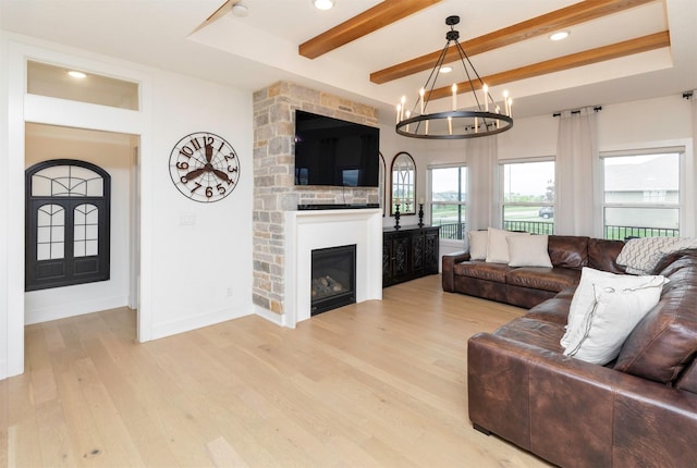 5018 NE Seneca Dr, Ankeny, IA 50021 - living area with light wood finished floors, a chandelier, beamed ceiling, recessed lighting, and a fireplace