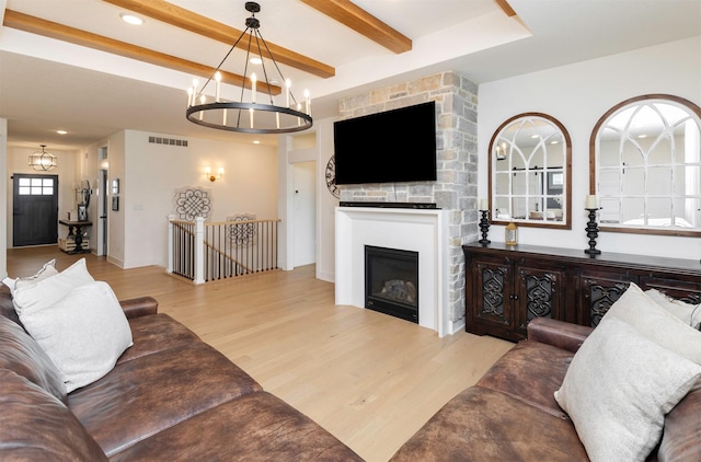 5018 NE Seneca Dr, Ankeny, IA 50021 - living area with a chandelier, wood finished floors, beamed ceiling, a fireplace, and recessed lighting
