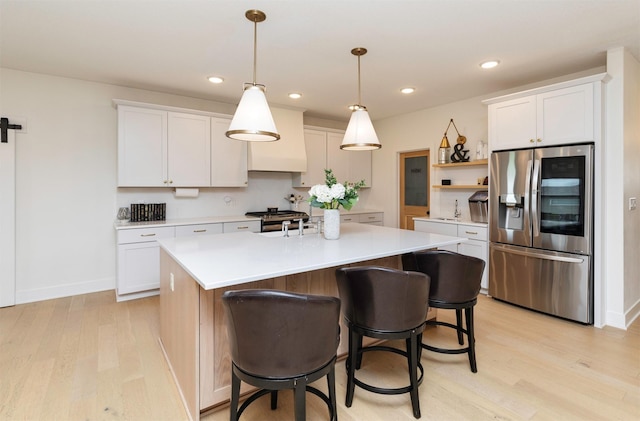 5018 NE Seneca Dr, Ankeny, IA 50021 - kitchen featuring stainless steel refrigerator with ice dispenser, open shelves, light wood-type flooring, custom range hood, and recessed lighting