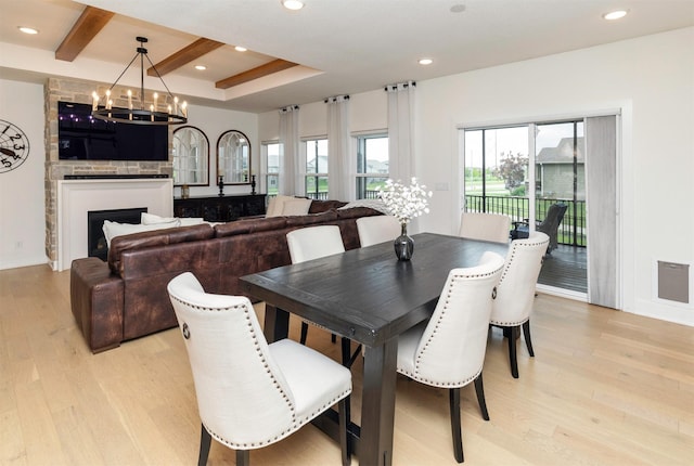 5018 NE Seneca Dr, Ankeny, IA 50021 - dining space featuring light wood-type flooring, a chandelier, recessed lighting, baseboards, and a raised ceiling