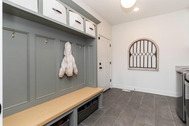 5018 NE Seneca Dr, Ankeny, IA 50021 - mudroom featuring baseboards and dark tile patterned flooring