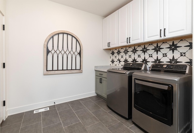 5018 NE Seneca Dr, Ankeny, IA 50021 - washroom with washer and clothes dryer, cabinet space, baseboards, and dark tile patterned flooring
