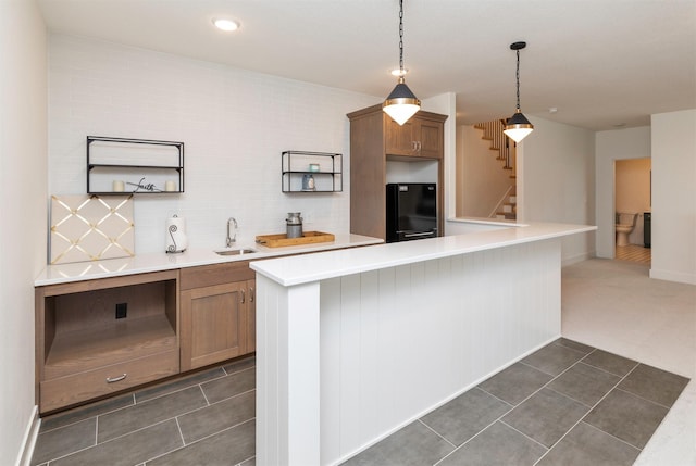 5018 NE Seneca Dr, Ankeny, IA 50021 - kitchen with freestanding refrigerator, a sink, light countertops, dark tile patterned flooring, and recessed lighting