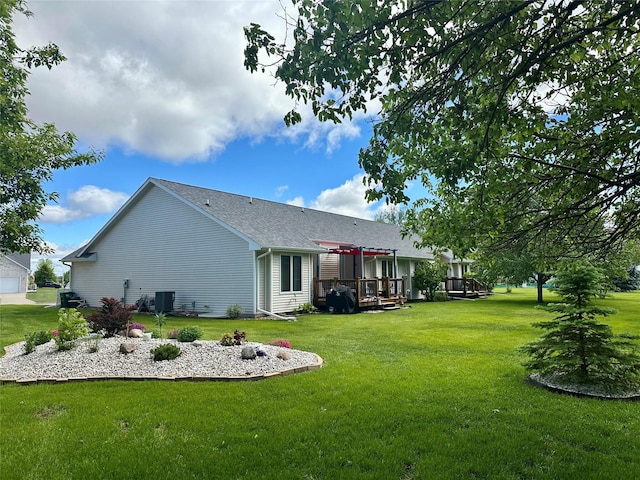 902 W Filmore St, Winterset, IA 50273 - rear view of property with a yard, a deck, central AC, and roof with shingles