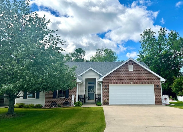 902 W Filmore St, Winterset, IA 50273 - view of front of home featuring brick siding, driveway, a garage, a front yard, and roof with shingles
