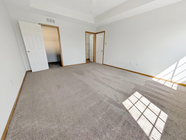 2101 Meadow Ct Unit 1304, Des Moines, IA 50320 - unfurnished bedroom featuring carpet flooring, baseboards, and a tray ceiling