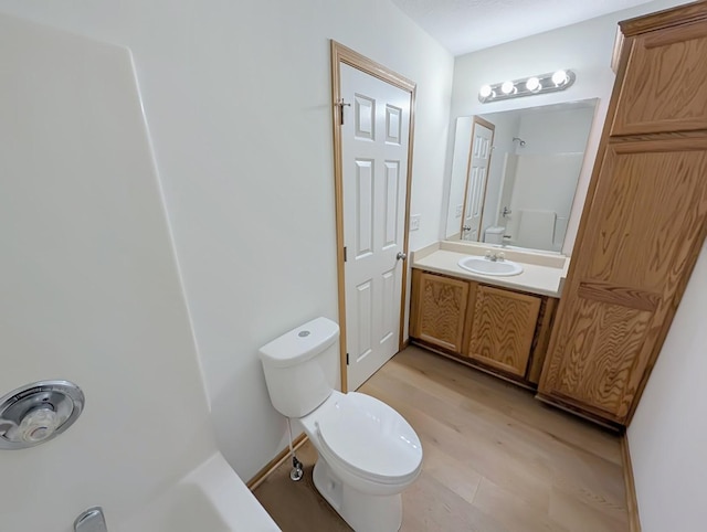 2101 Meadow Ct Unit 1304, Des Moines, IA 50320 - full bathroom with vanity, toilet, and wood finished floors