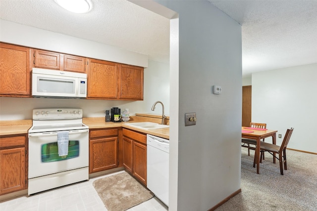 4829 86th St Unit 6, Urbandale, IA 50322 - kitchen featuring white appliances, a sink, light countertops, a textured ceiling, and brown cabinetry