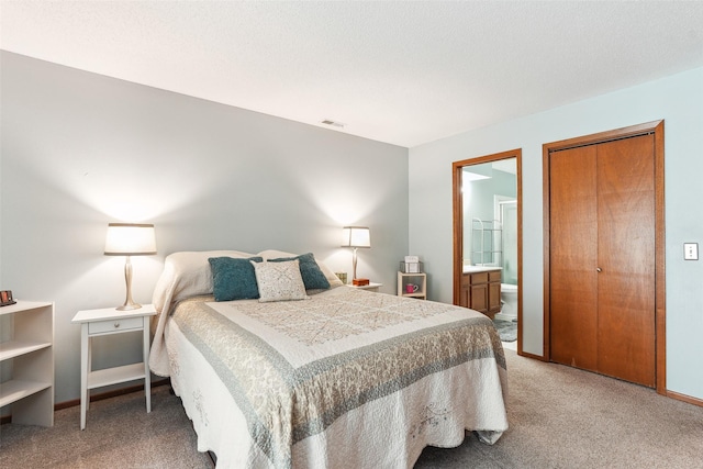 4829 86th St Unit 6, Urbandale, IA 50322 - carpeted bedroom with ensuite bathroom and baseboards