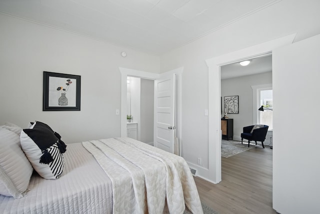 1519 Searle St, Des Moines, IA 50317 - bedroom featuring light wood finished floors and crown molding