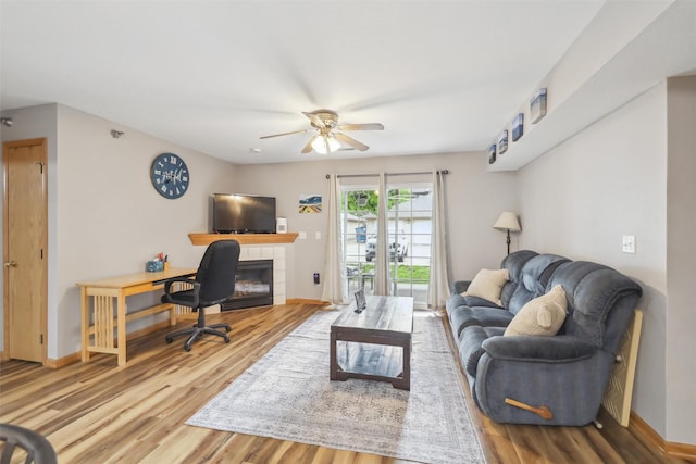 1265 SE 6th St Unit 104, Grimes, IA 50111 - living room with a ceiling fan, wood finished floors, and baseboards