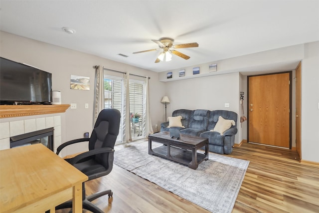 1265 SE 6th St Unit 104, Grimes, IA 50111 - office space featuring ceiling fan, wood finished floors, a fireplace, and baseboards