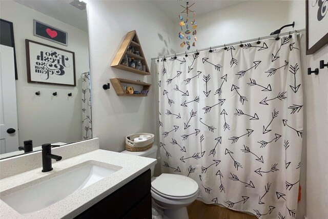 1932 Strauss Ave, Adel, IA 50003 - bathroom featuring vanity, toilet, and a shower with curtain