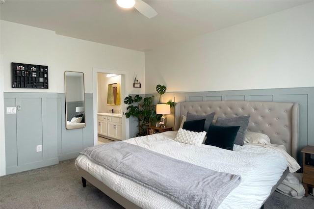 1932 Strauss Ave, Adel, IA 50003 - bedroom featuring light carpet, ensuite bathroom, ceiling fan, and a wainscoted wall