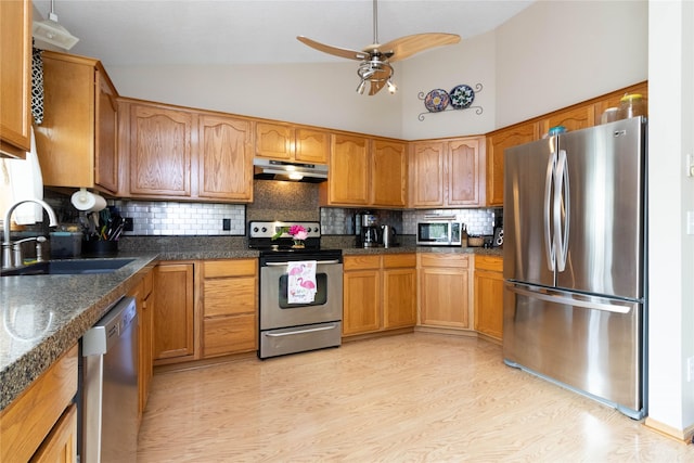 704 13th St SE, Altoona, IA 50009 - kitchen with appliances with stainless steel finishes, a sink, under cabinet range hood, ceiling fan, and brown cabinets