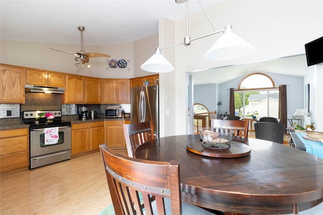 704 13th St SE, Altoona, IA 50009 - dining area with light wood finished floors, vaulted ceiling, and ceiling fan