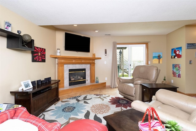 704 13th St SE, Altoona, IA 50009 - tiled living area with a tile fireplace and recessed lighting