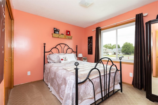704 13th St SE, Altoona, IA 50009 - bedroom with baseboards and light carpet