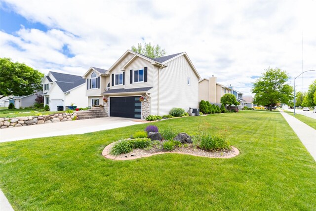 704 13th St SE, Altoona, IA 50009 - view of front of property featuring a garage, stone siding, driveway, a front lawn, and a residential view