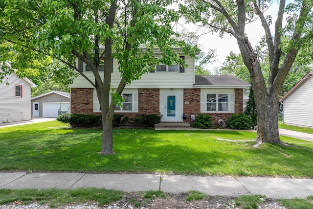 500 8th St, Waukee, IA 50263 - view of front facade featuring brick siding, a detached garage, an outdoor structure, and a front yard