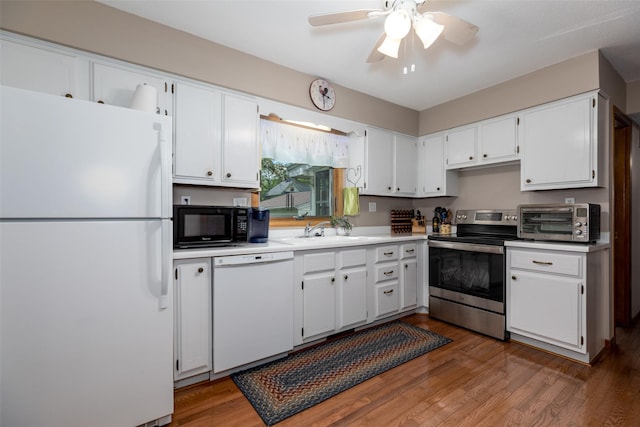 500 8th St, Waukee, IA 50263 - kitchen with white appliances, a sink, white cabinets, and a ceiling fan