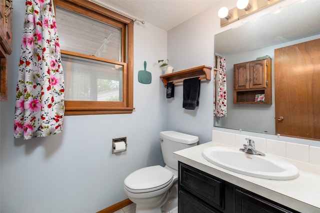 500 8th St, Waukee, IA 50263 - bathroom featuring toilet, vanity, and baseboards