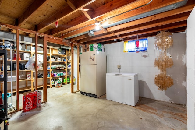 500 8th St, Waukee, IA 50263 - basement featuring freestanding refrigerator, refrigerator, and concrete block wall