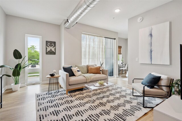 450 SW 7th St Unit 205, Des Moines, IA 50309 - living room featuring light wood-style floors, baseboards, and recessed lighting