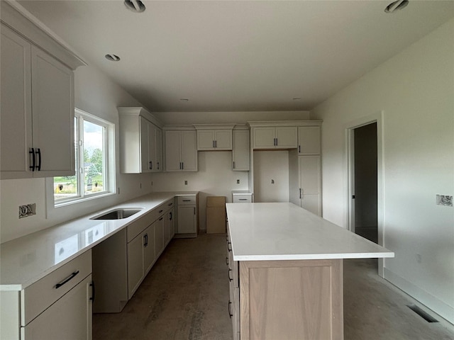 305 NW Woodmoor Dr, Waukee, IA 50263 - kitchen with a center island, concrete floors, recessed lighting, and white cabinets