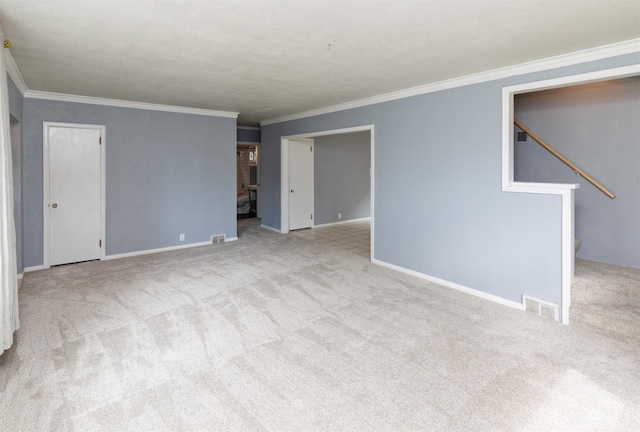 4101 Muskogee Ave, Des Moines, IA 50312 - unfurnished room with carpet floors, crown molding, baseboards, and stairway
