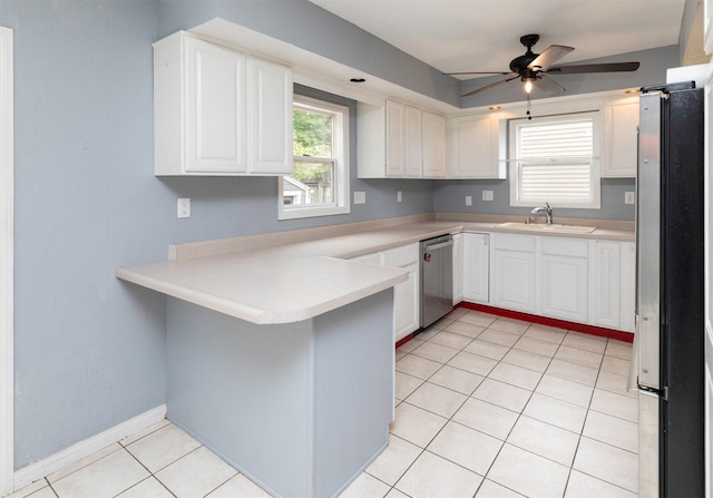 4101 Muskogee Ave, Des Moines, IA 50312 - kitchen with stainless steel appliances, a sink, a peninsula, and white cabinets