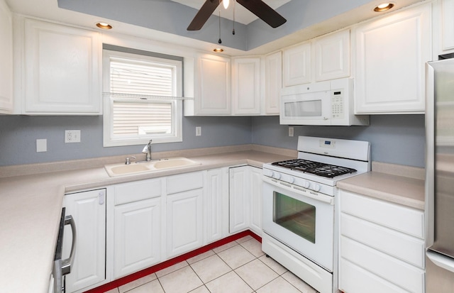 4101 Muskogee Ave, Des Moines, IA 50312 - kitchen featuring white appliances, a sink, a ceiling fan, light tile patterned floors, and white cabinetry
