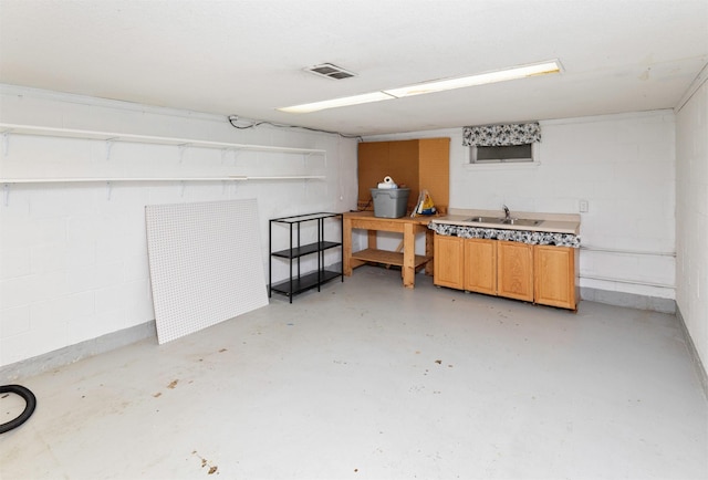 4101 Muskogee Ave, Des Moines, IA 50312 - miscellaneous room featuring concrete flooring, concrete block wall, and a sink