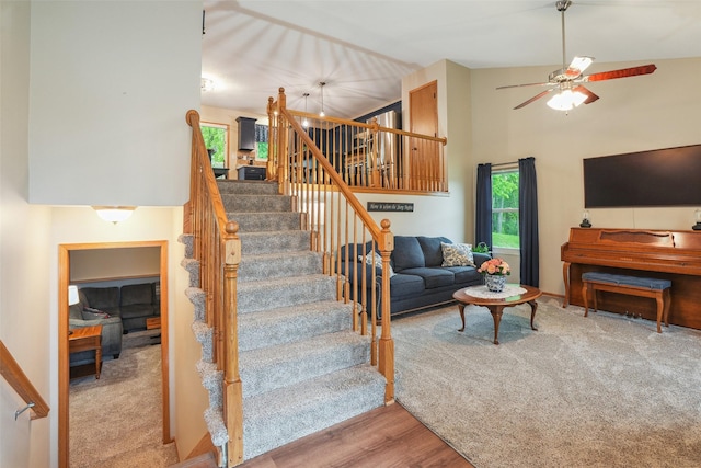 5200 Pine Valley Dr, Pleasant Hill, IA 50327 - staircase with ceiling fan, wood finished floors, and high vaulted ceiling