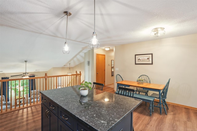 5200 Pine Valley Dr, Pleasant Hill, IA 50327 - kitchen with ceiling fan, wood finished floors, pendant lighting, a center island, and dark cabinets