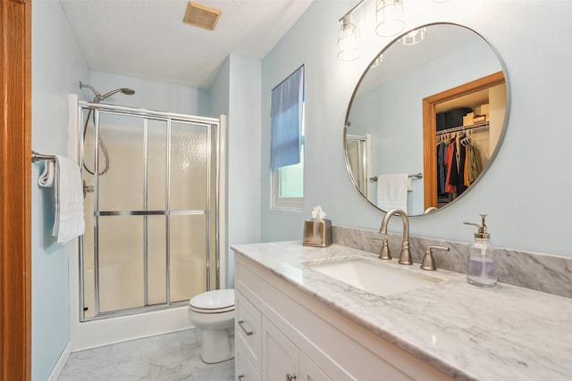 5200 Pine Valley Dr, Pleasant Hill, IA 50327 - full bathroom with marble finish flooring, vanity, a stall shower, and toilet