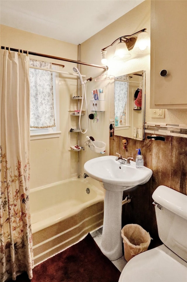 3517 50th St, Des Moines, IA 50310 - bathroom featuring shower / bathtub combination with curtain and toilet