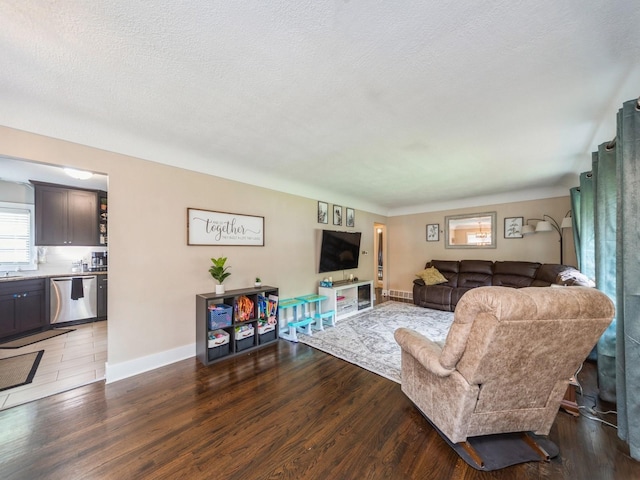 4022 Clinton Ave, Des Moines, IA 50310 - living room with baseboards, wood finished floors, and a textured ceiling