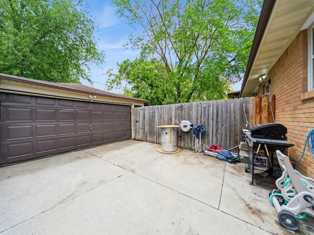 4022 Clinton Ave, Des Moines, IA 50310 - view of patio / terrace featuring area for grilling, a detached garage, and an outdoor structure