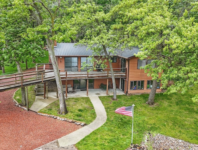 5113 Panorama Dr, Panora, IA 50216 - back of property featuring a patio, a wooden deck, a lawn, and a chimney