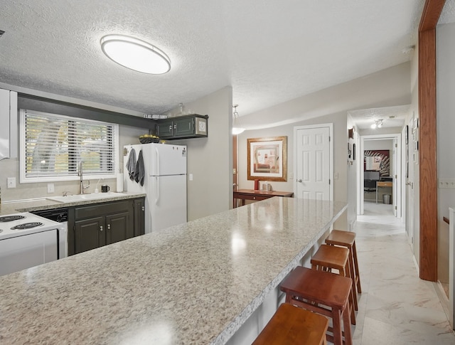 5113 Panorama Dr, Panora, IA 50216 - kitchen featuring white appliances, light marble finish floors, a sink, a breakfast bar area, and a textured ceiling