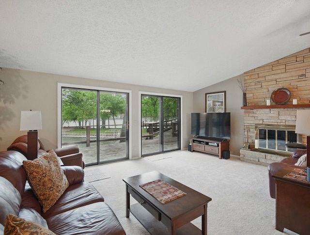 5113 Panorama Dr, Panora, IA 50216 - carpeted living area featuring lofted ceiling, a stone fireplace, and a textured ceiling