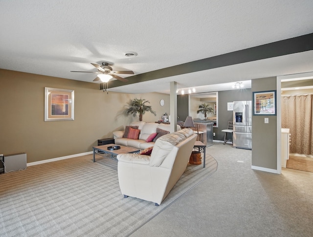 5113 Panorama Dr, Panora, IA 50216 - living area featuring light carpet, baseboards, ceiling fan, and a textured ceiling