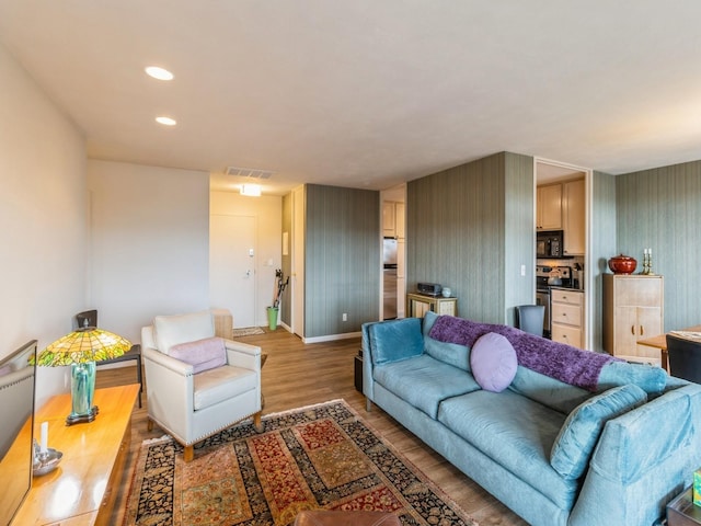 3663 Grand Ave Unit 508, Des Moines, IA 50312 - living area with wallpapered walls, light wood-style floors, baseboards, and recessed lighting