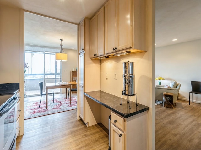 3663 Grand Ave Unit 508, Des Moines, IA 50312 - kitchen with light wood-style floors, light brown cabinets, recessed lighting, and stainless steel range with electric stovetop