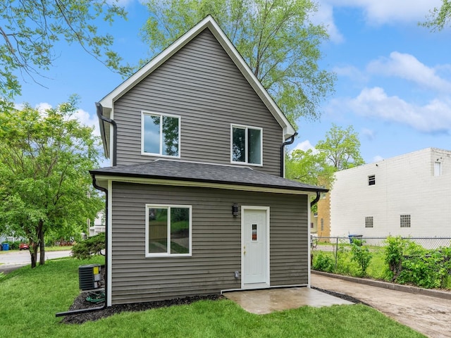 2917 2nd Ave, Des Moines, IA 50313 - rear view of house featuring central AC and roof with shingles